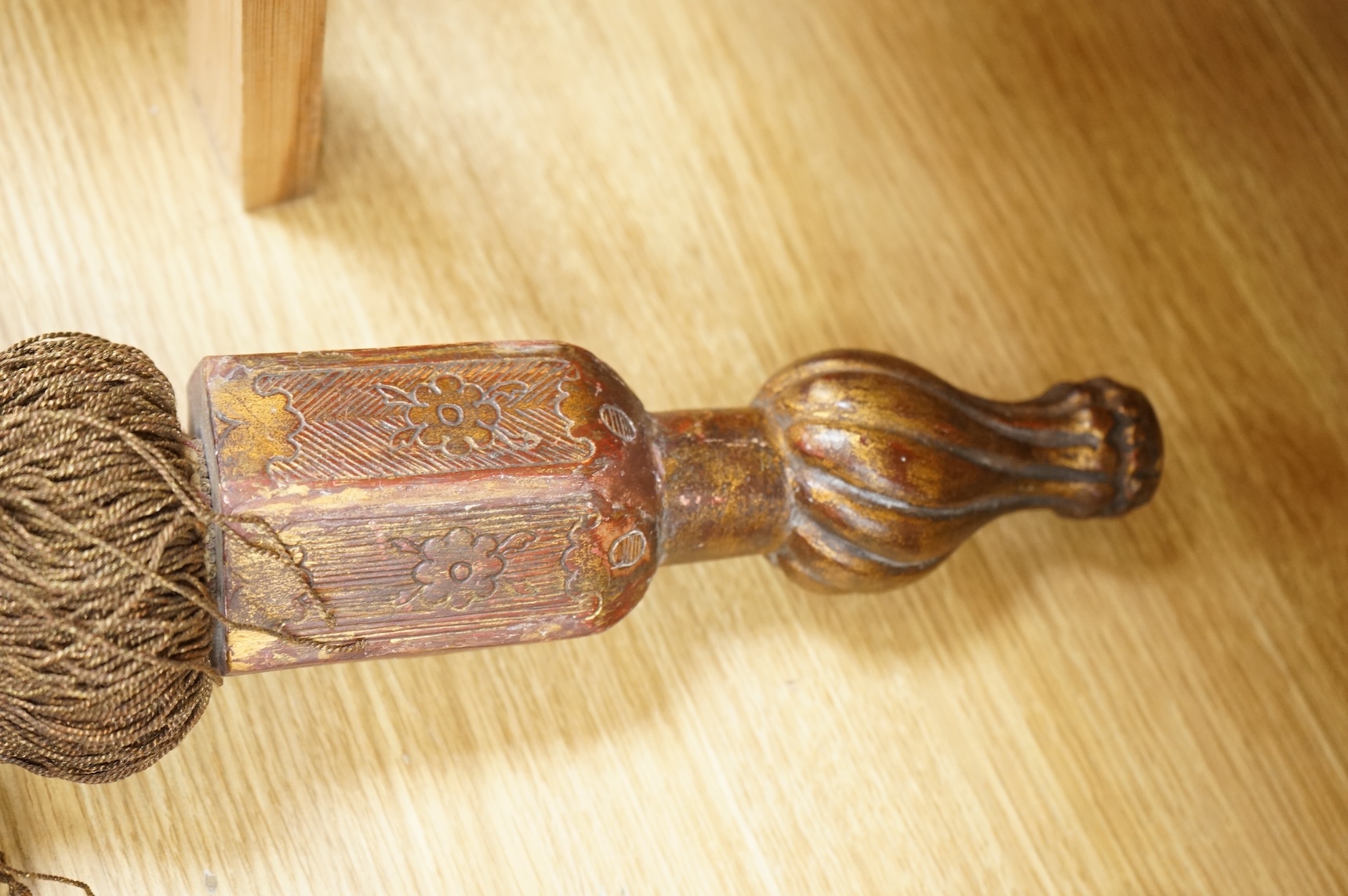 A pair of 19th century Venetian carved wood and tasseled tie-backs